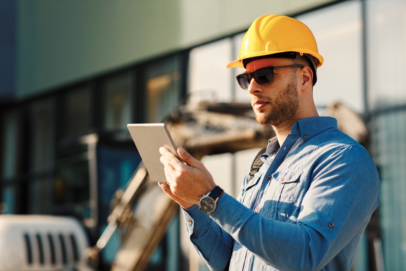 Construction engineer using digital tablet on the construction site