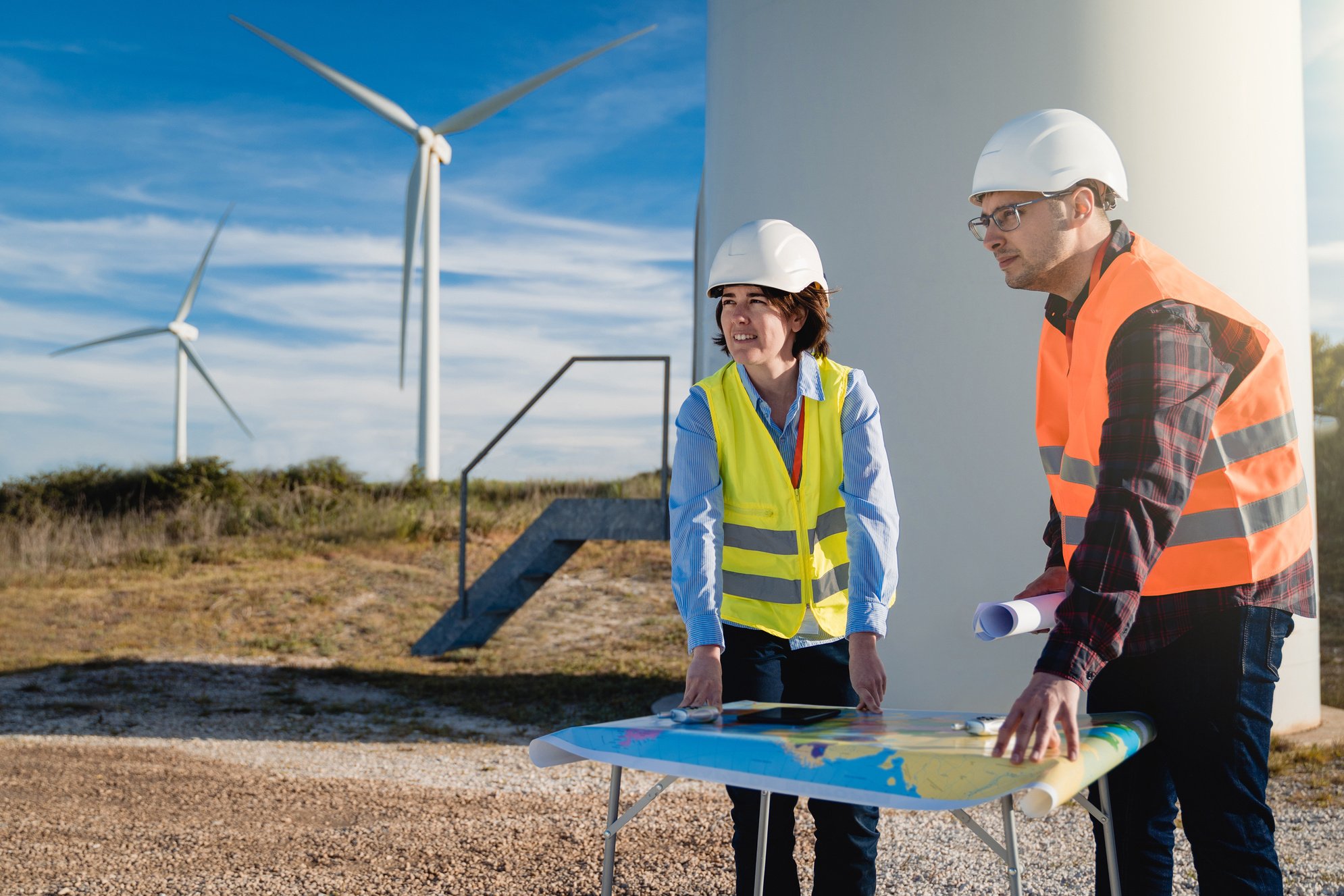 Engineers working at alternative renewable wind energy farm - Sustainable energy industry concept