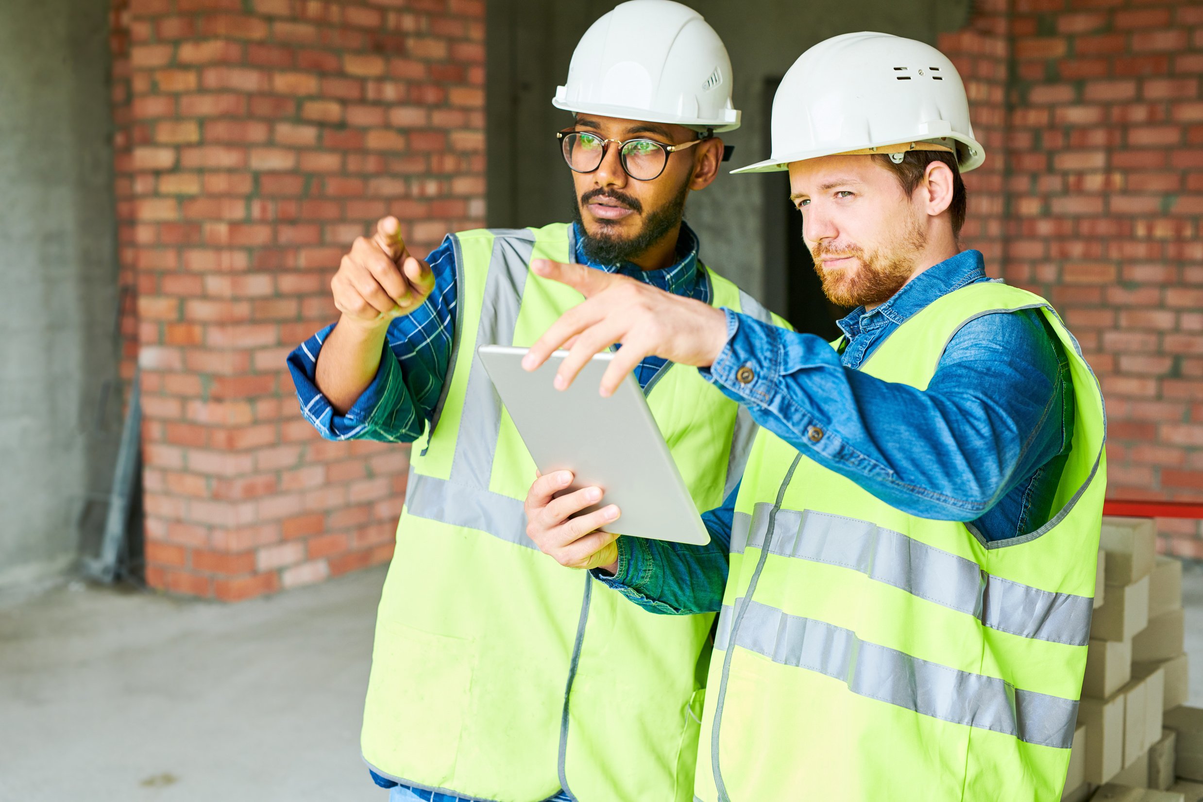 Construction Workers Using Digital Tablet