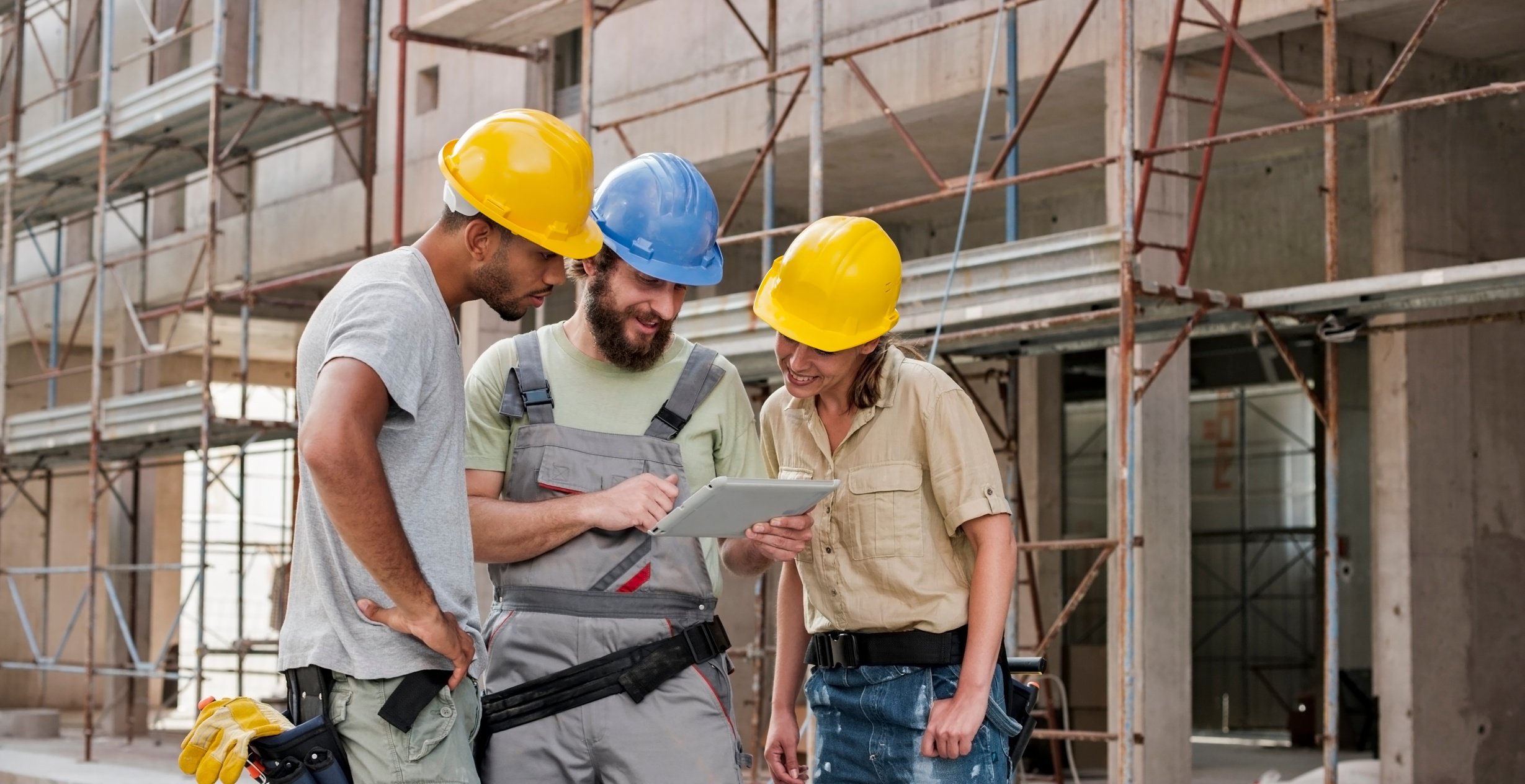 Construction workers using digital tablet