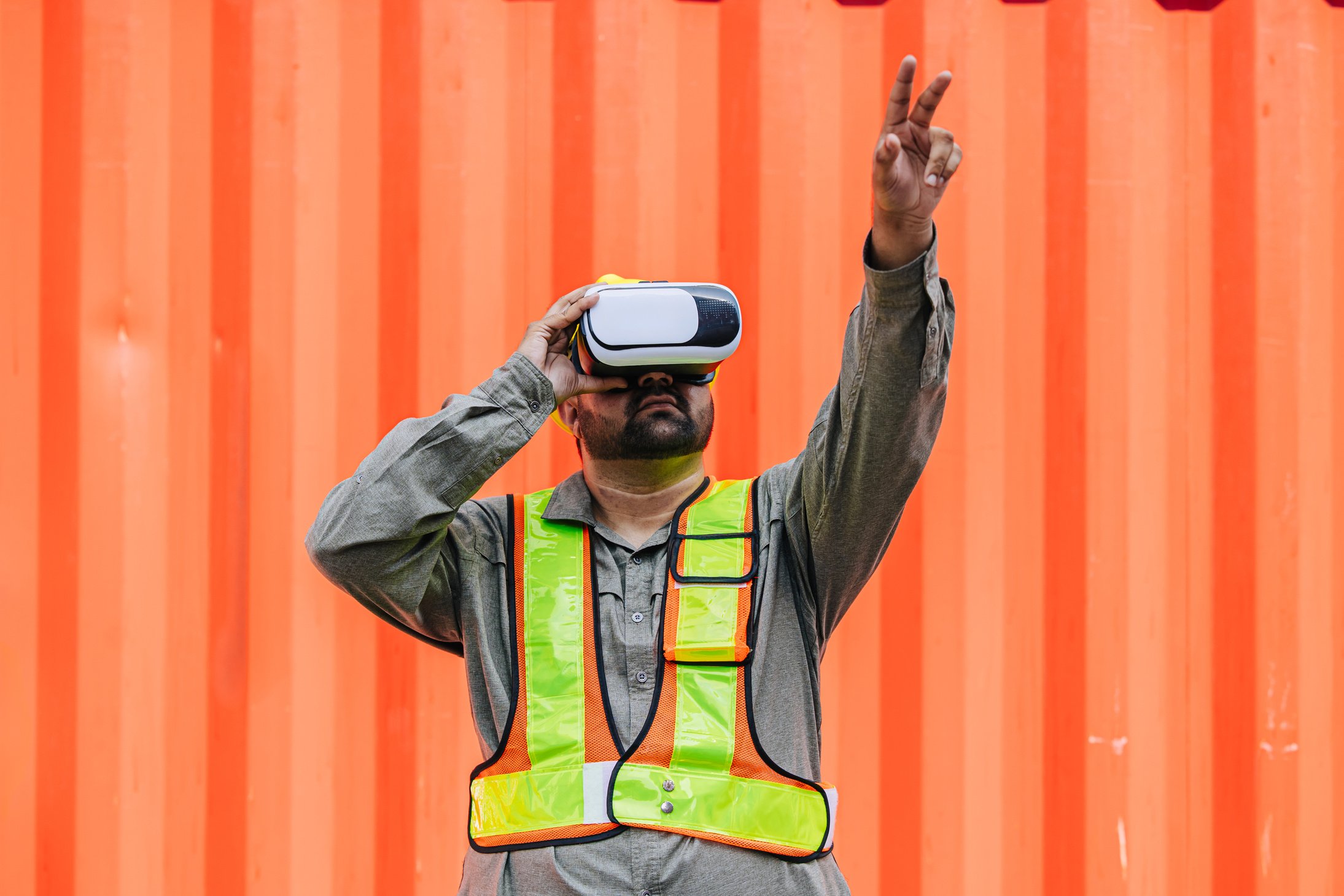 Worker Using VR Vision Pro Technology Equipment Headset Device Work at Container Yard Construction site Innovation in Logistics Industry